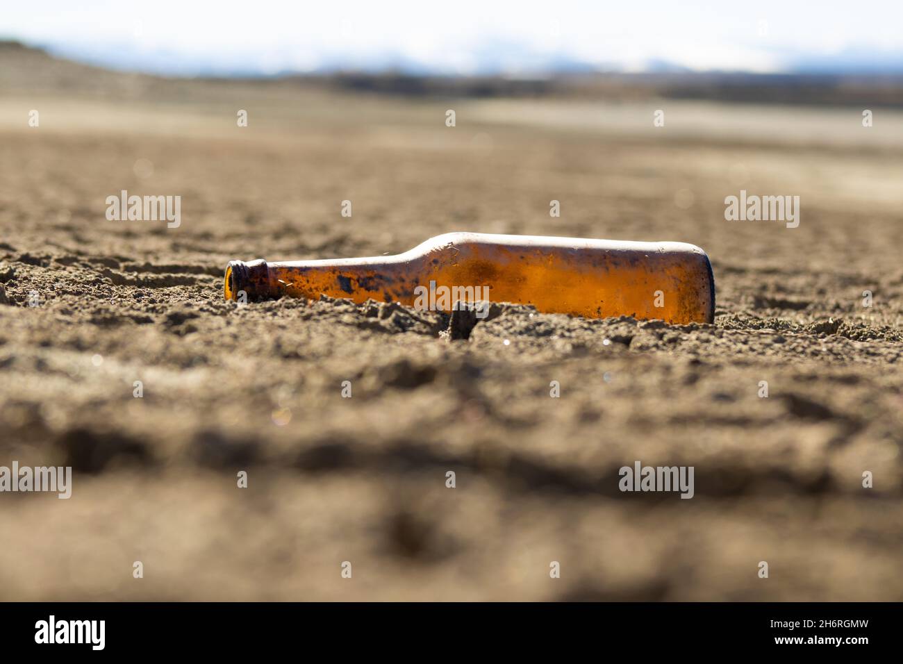 Bottle in sand trash environment Stock Photo