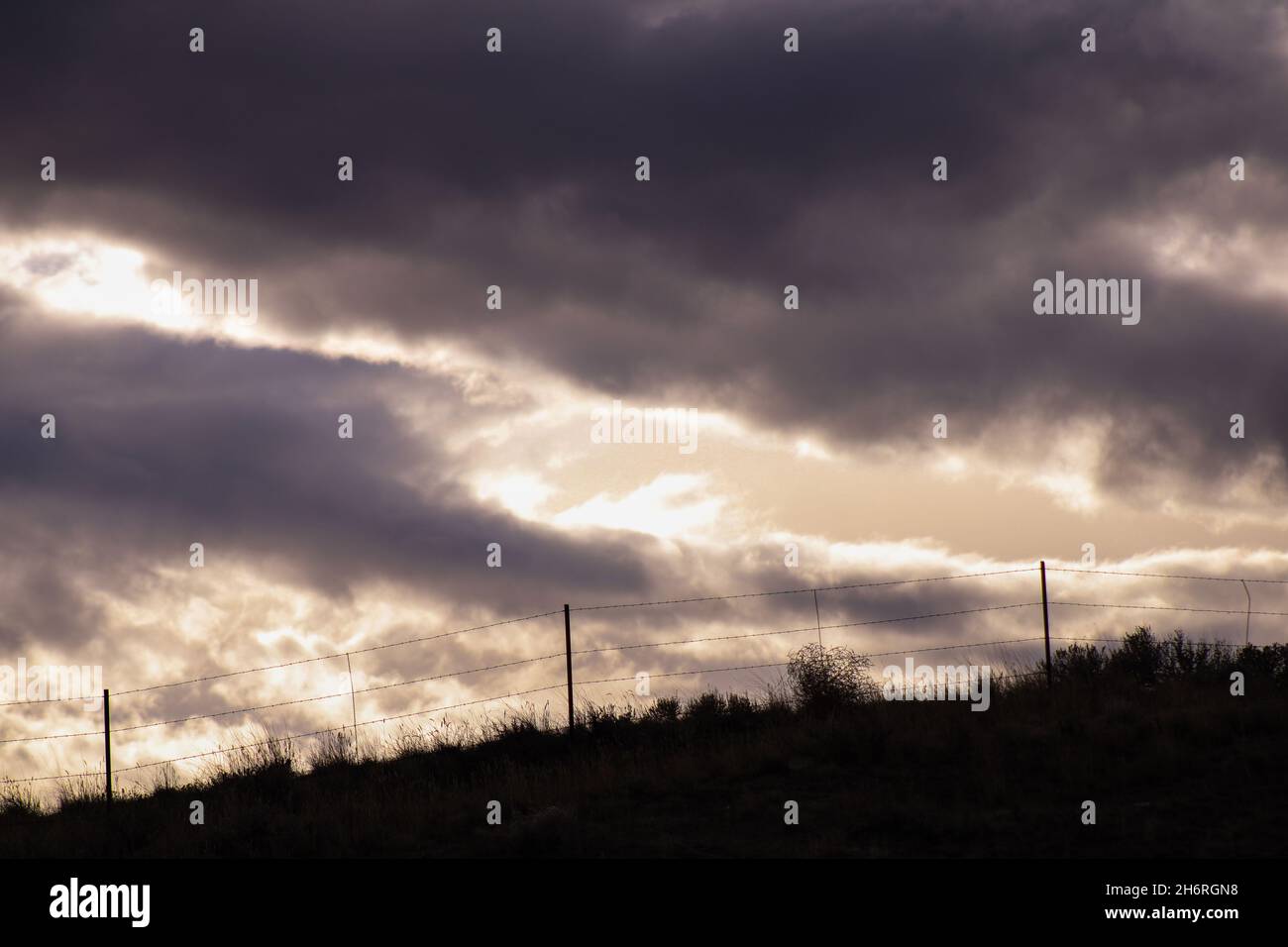 Sunset over a pasture land relaxing farming outdoors Stock Photo