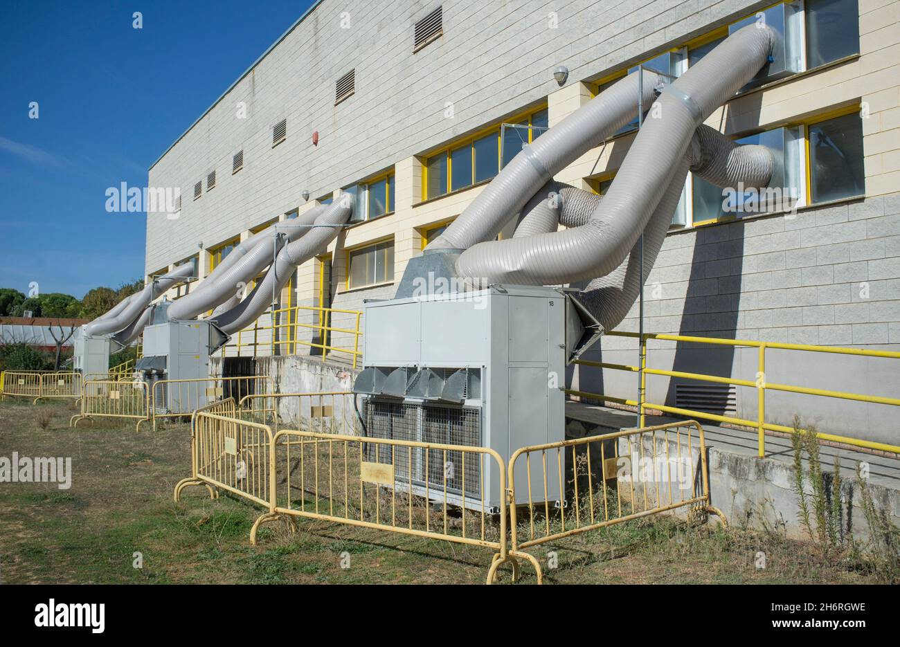 Temporary air conditioning machinery outdoors. Huge tubes are inserted from outside Stock Photo