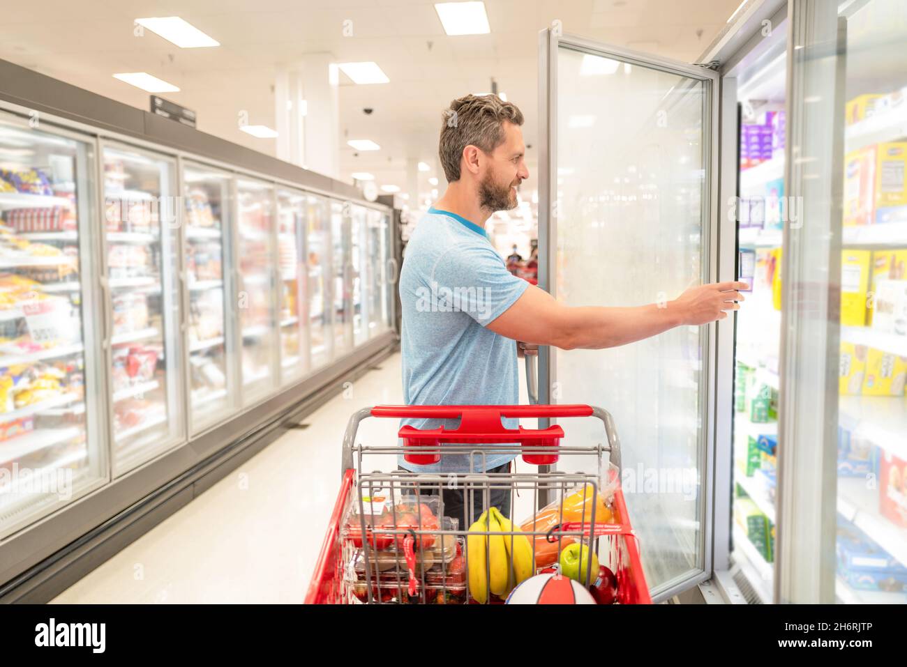 happy man with shopping cart. customer consumer with purchases. guy at