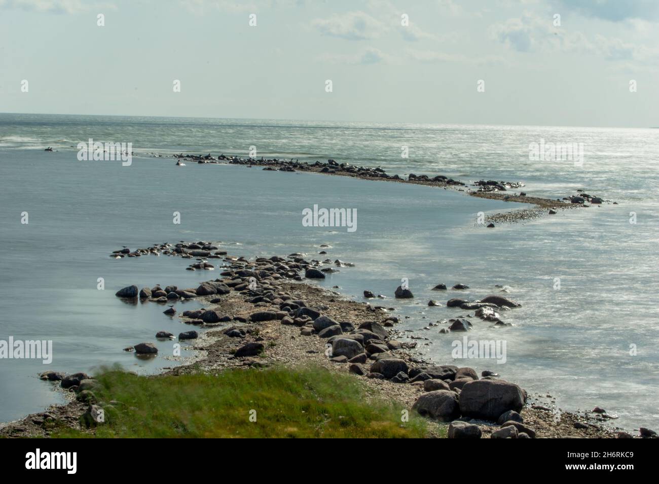 Landscape of rocks in the sea under a cloudy sky and sunligh Stock ...