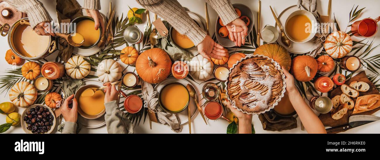 People eating over fall festive table set, top view Stock Photo