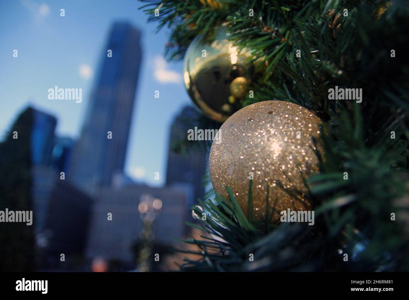 Close up of Christmas ball decorations with skyscrapers on the back in a winter sunny day Stock Photo