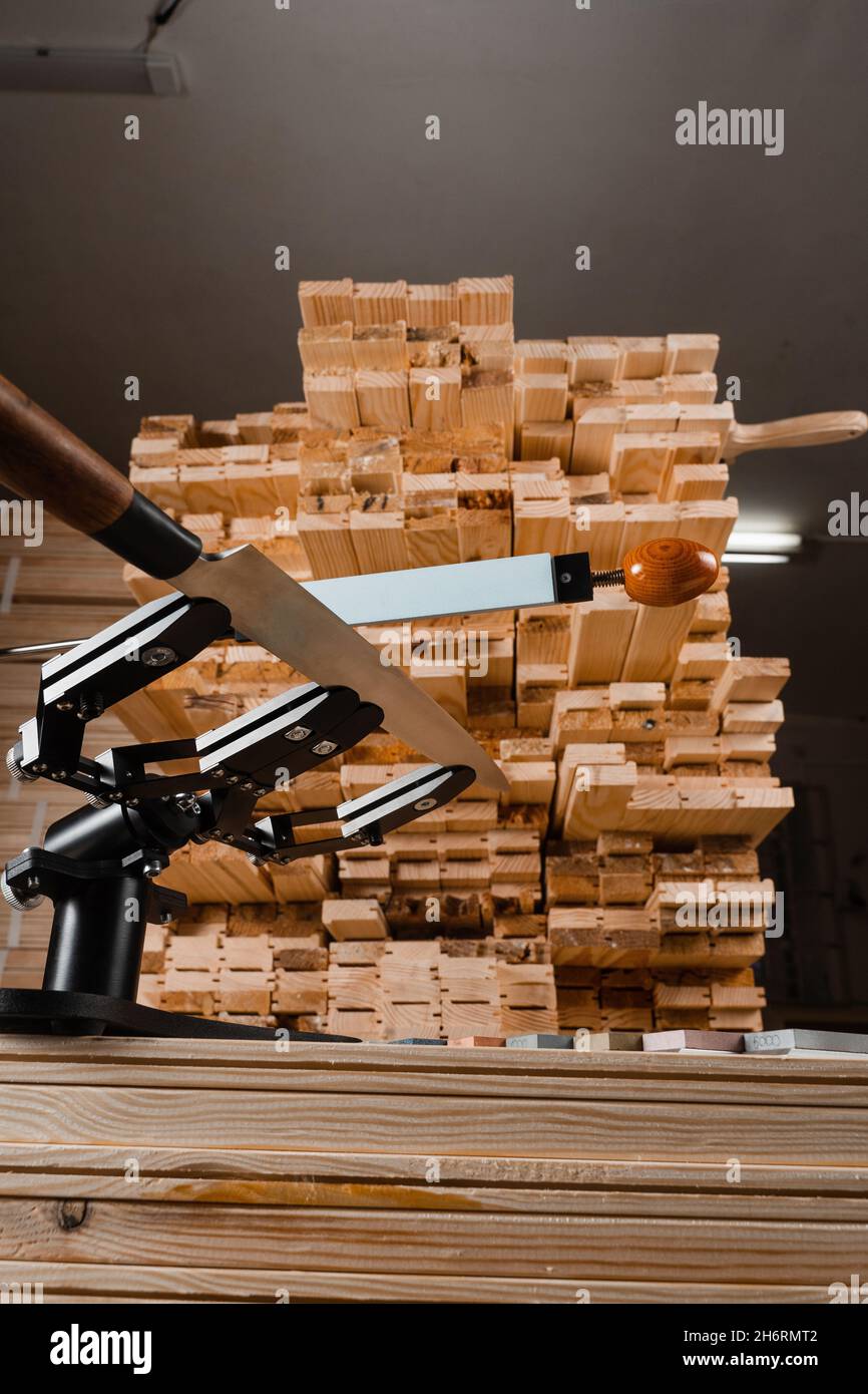 Sharpening knife process using professional sharpener with whetstone in