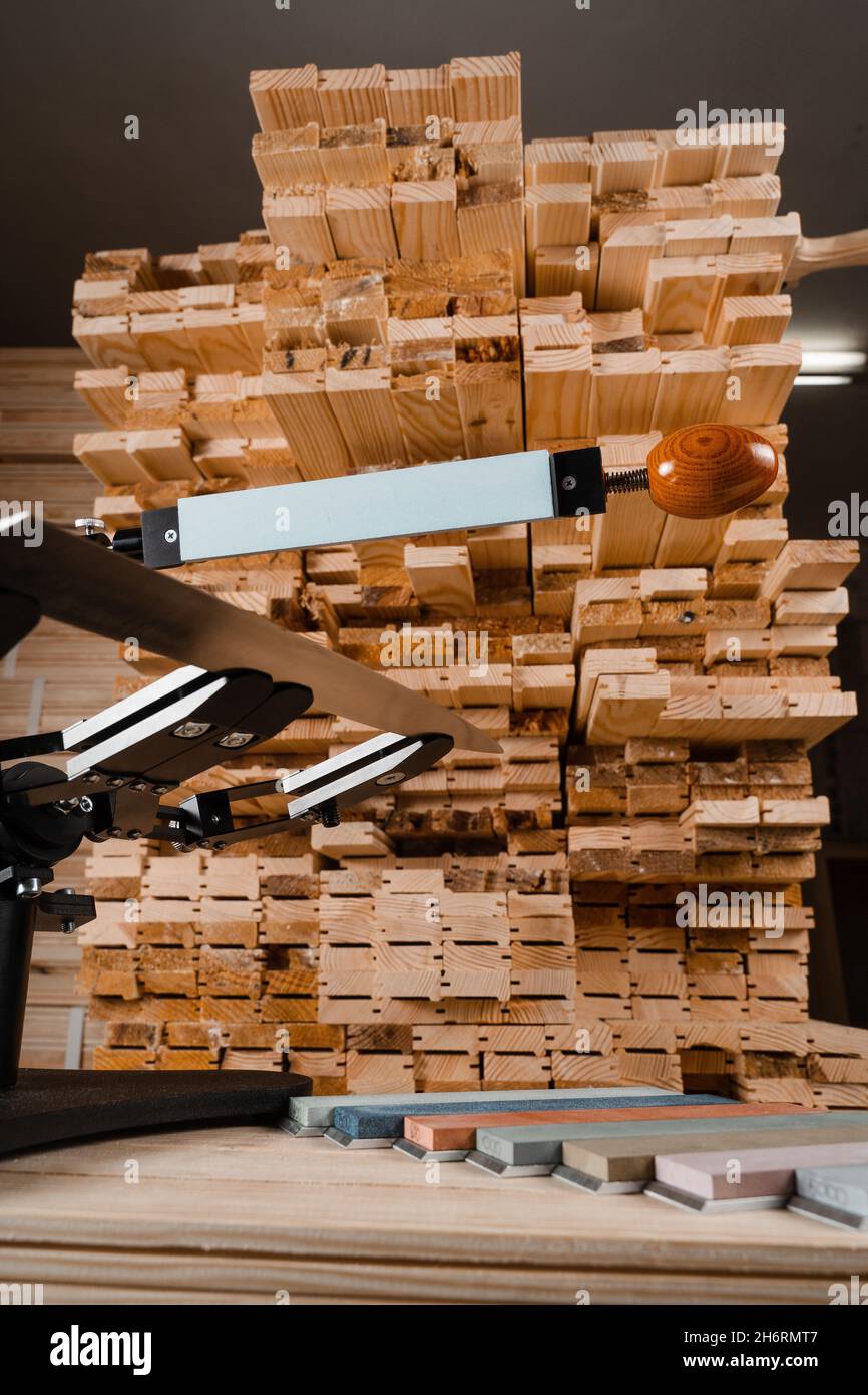 Sharpening knife process using professional sharpener with whetstone in