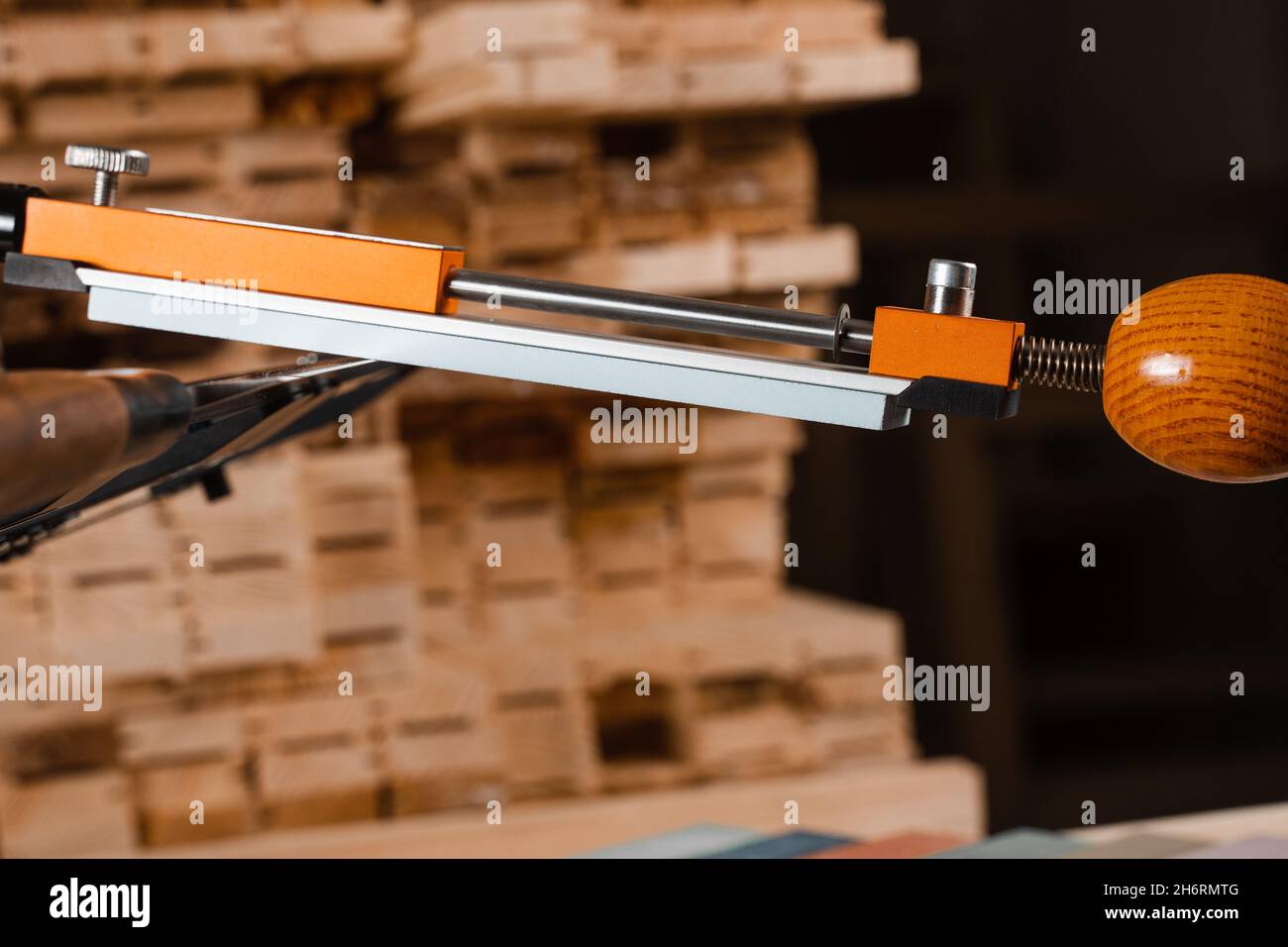 Sharpening knife process using professional sharpener with whetstone in