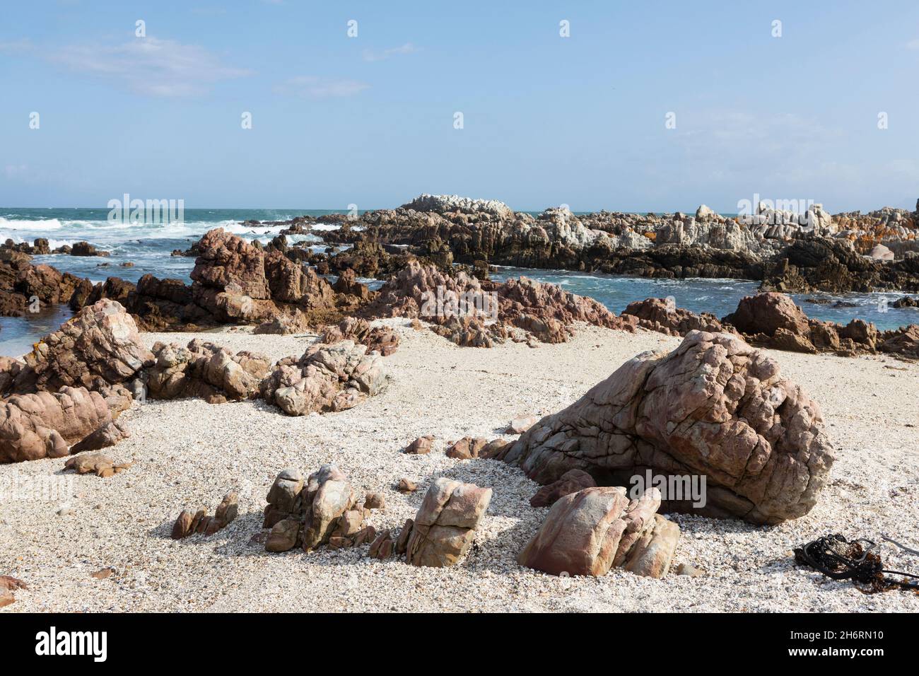 Sand and shingle beach with jagged rocks, on the Atlantic coast. Stock Photo