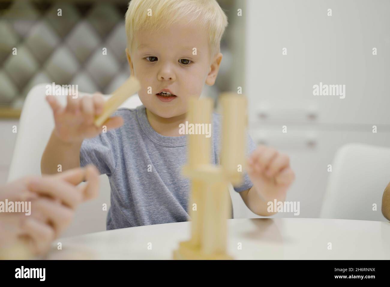 little boy have fun playing Jenga together board game to remove