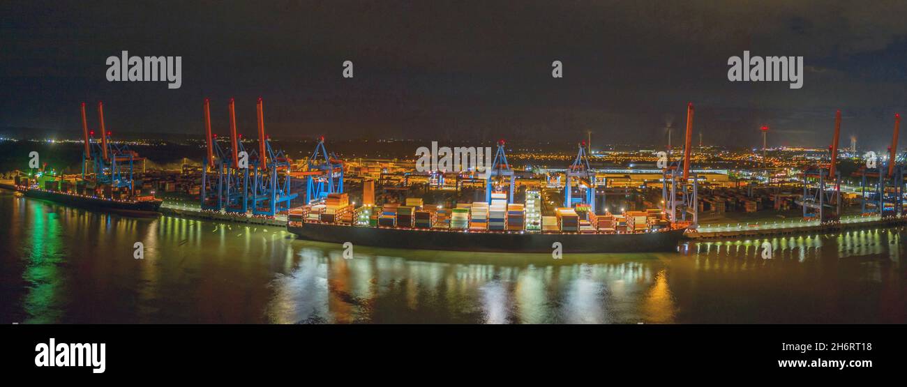 Container terminal , loading and unloading of various shipping container and the freight station in the night. A seaport on the river Elbe in Hamburg Stock Photo