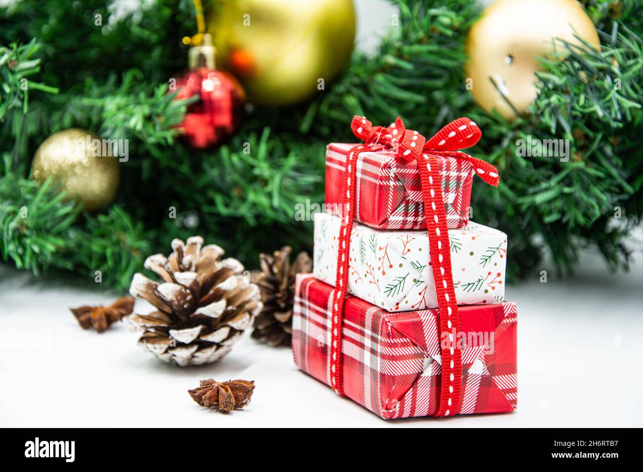Three gift boxes with ribbon bows and Christmas tree branch Stock Photo ...
