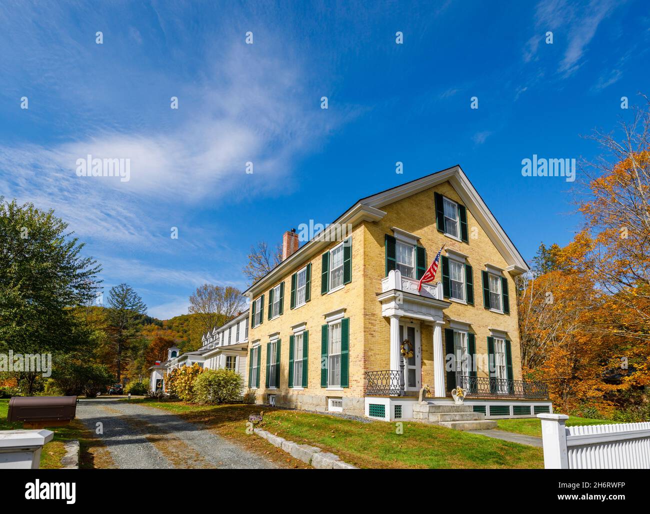 Typical local style large residential house with patriotic American flag in Woodstock, Vermont, New England, USA Stock Photo