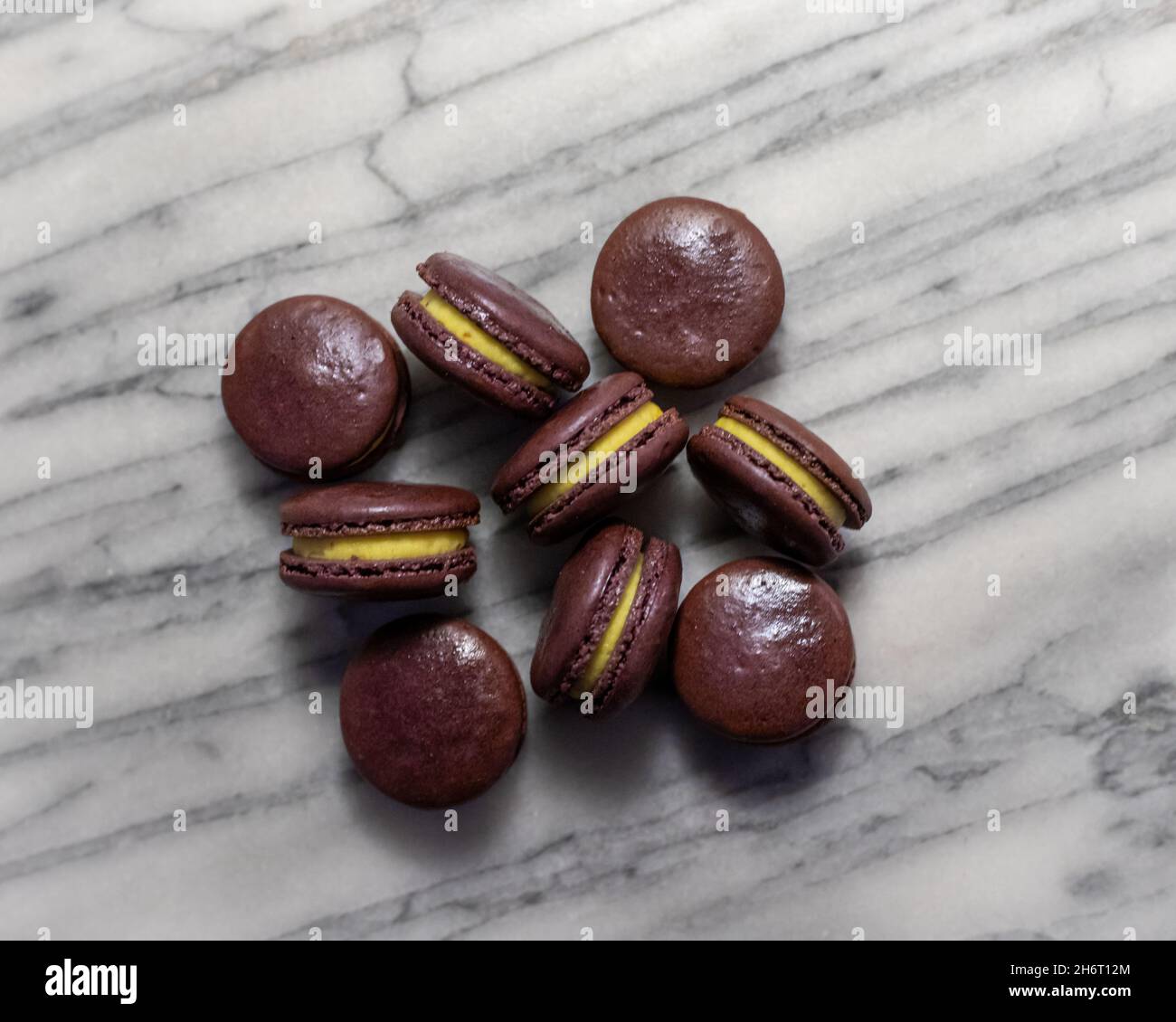 Passionfruit Macarons on White Marble Stock Photo