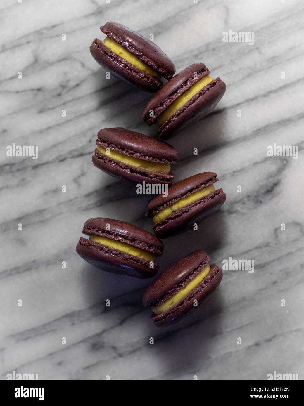Passionfruit Macarons on White Marble Stock Photo