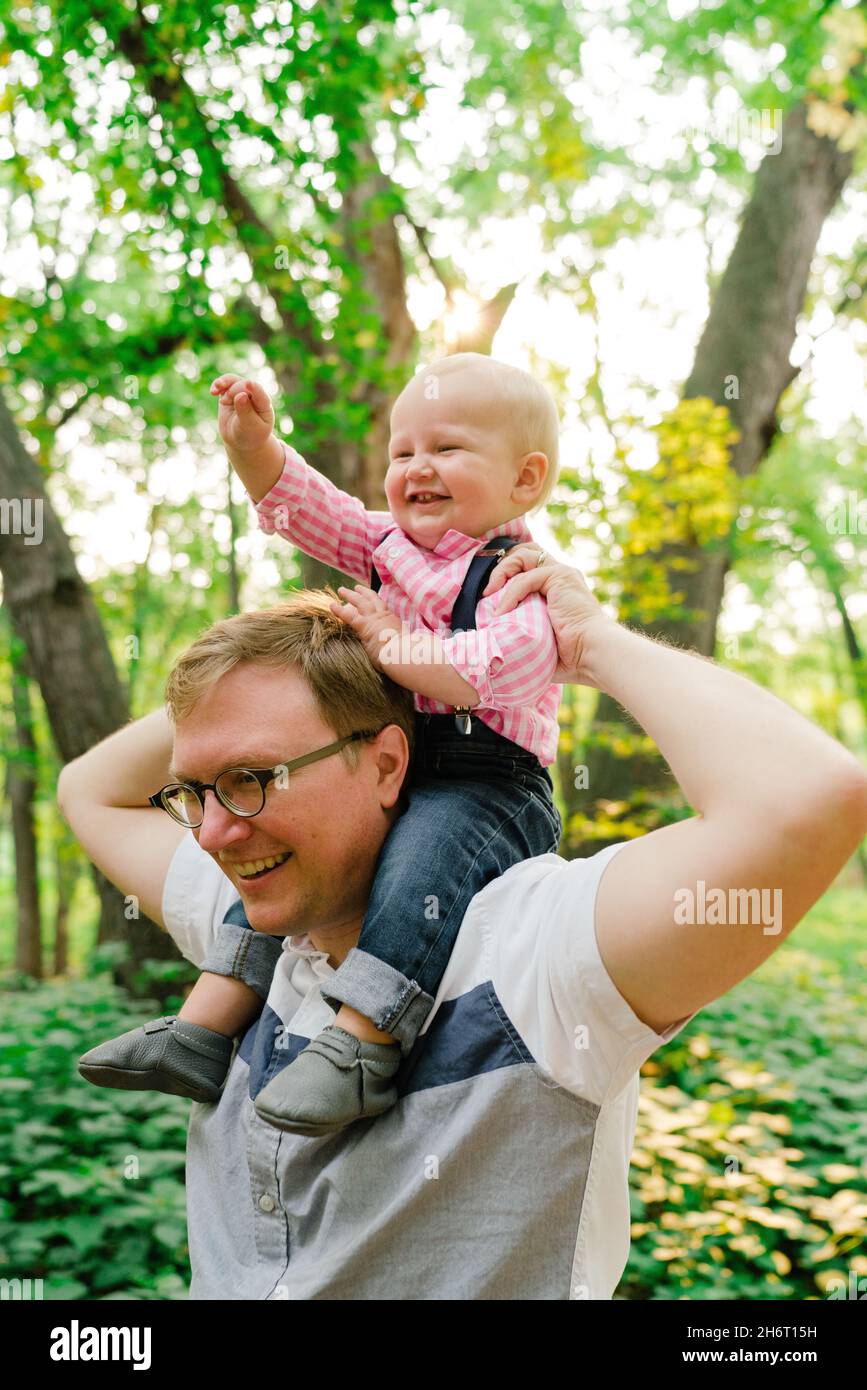 Closeup portrait of a baby boy on his dad's shoulders Stock Photo