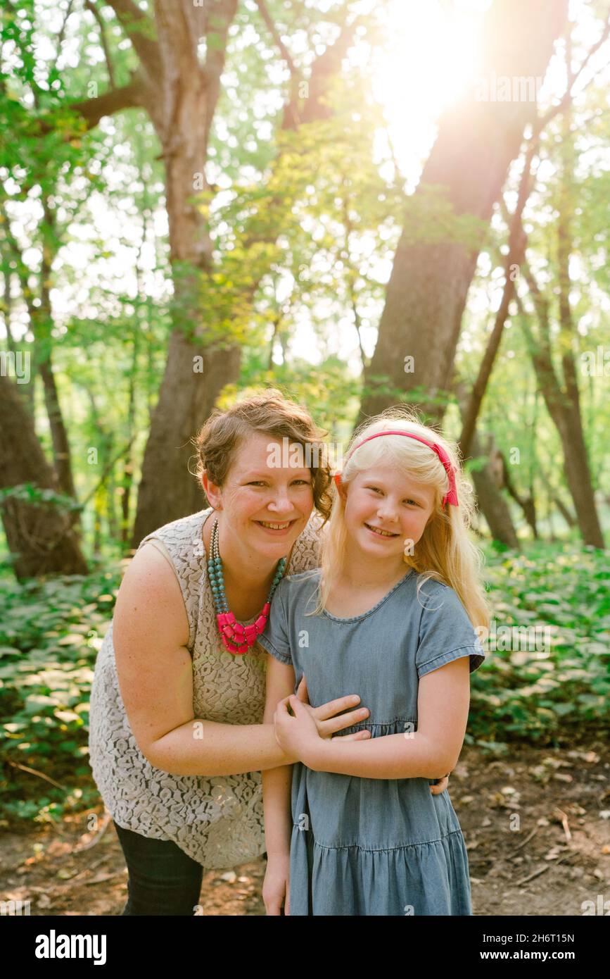 Straight on portrait of a mother and daughter in the forest Stock Photo
