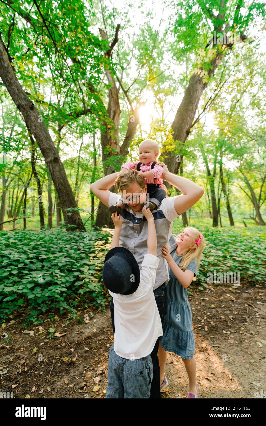 Lifestyle portrait of a father and three children Stock Photo