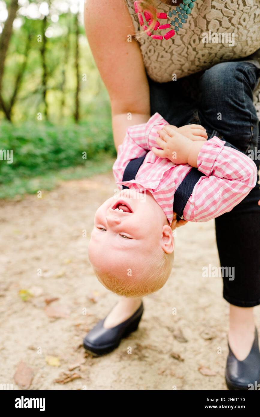 Closeup portrait of a baby being held upside down Stock Photo Alamy