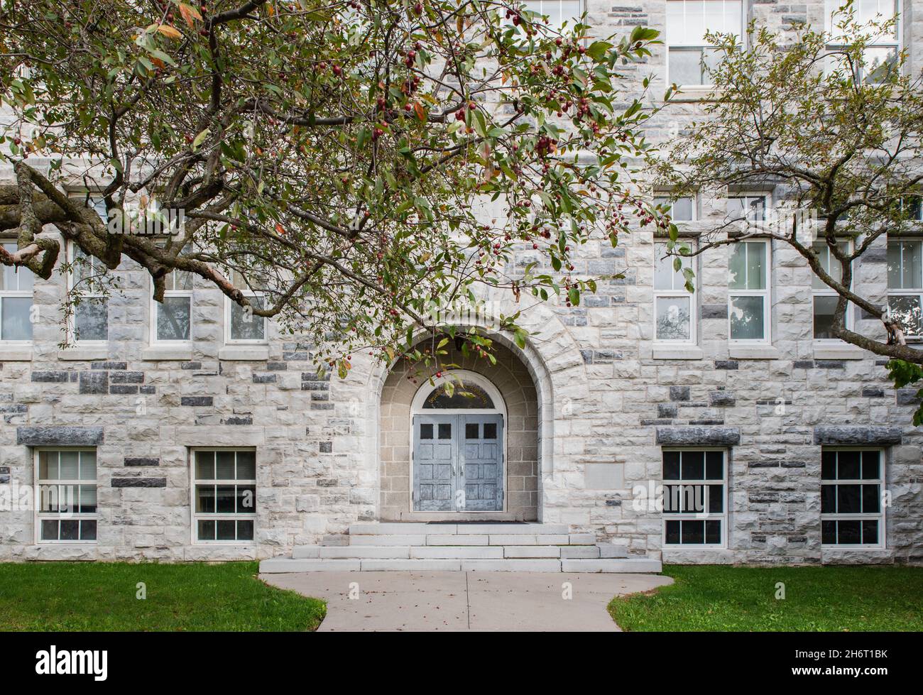 Facade of a limestone building on Queen's university campus. Stock Photo