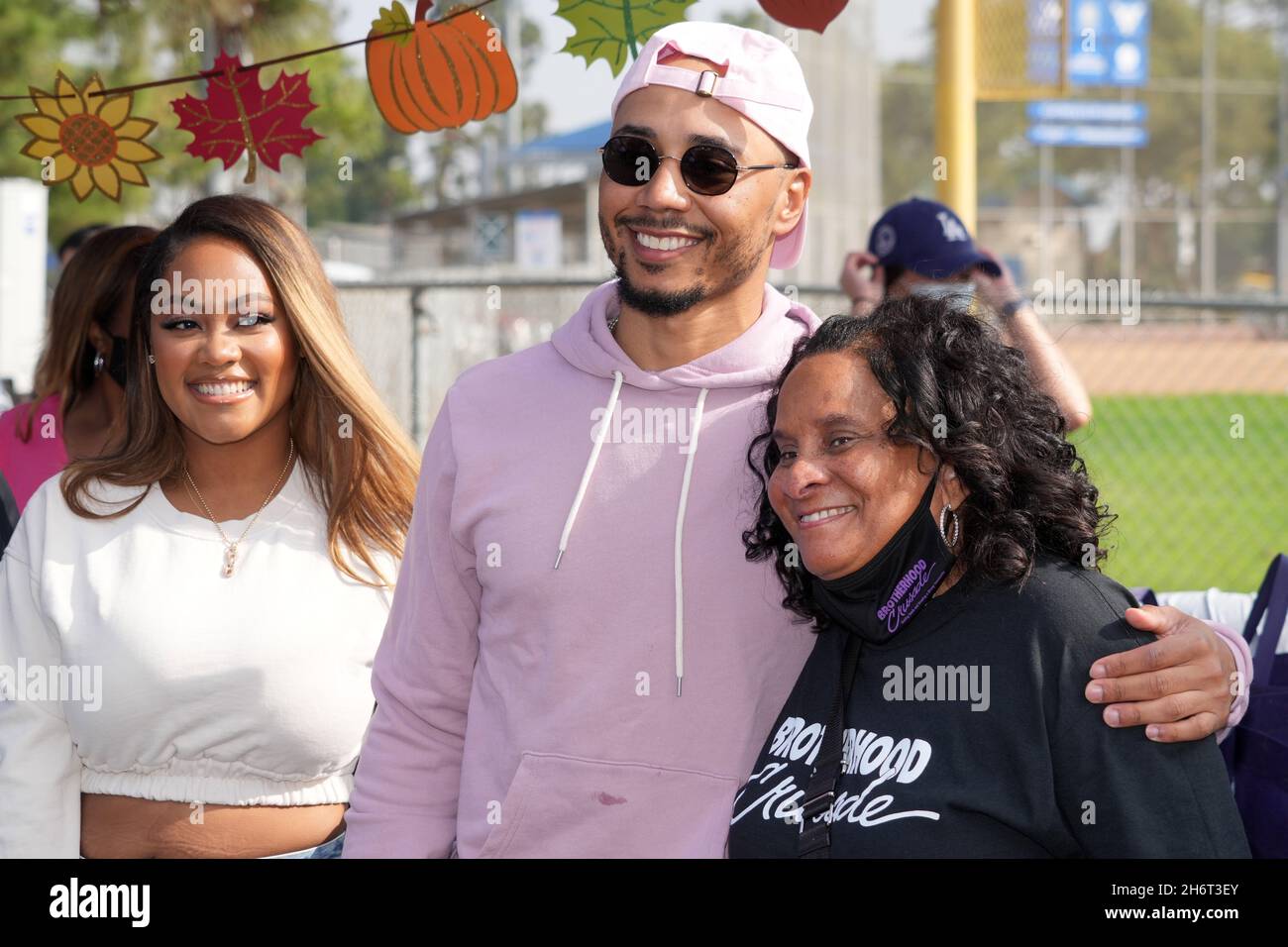 Mookie Betts (center) with fiance Brianna Hammonds (left) and Brotherhood Crusade president Charisse Bremond Weaver during the Los Angeles Dodgers Fou Stock Photo