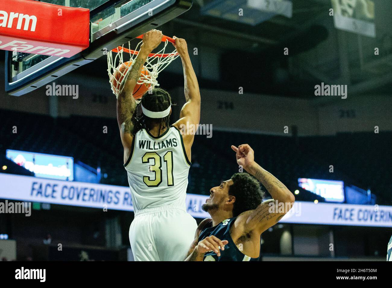 Winston-Salem, NC, USA. 17th Nov, 2021. Wake Forest Demon Deacons guard Alondes Williams (31) gets past Charleston Southern Buccaneers guard Sean Price (23) for a slam dunk during the first half of the NCAA Basketball matchup at LJVM Coliseum in Winston-Salem, NC. (Scott Kinser/Cal Sport Media). Credit: csm/Alamy Live News Stock Photo