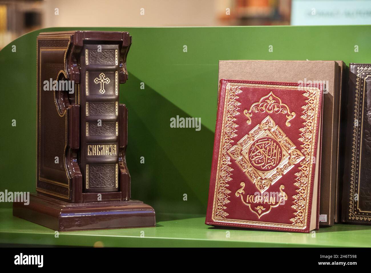 Picture of a Serbian language bible, christian orthodox, and a muslim lislamic kuran for sale in a window in Belgrade, Serbia. Stock Photo