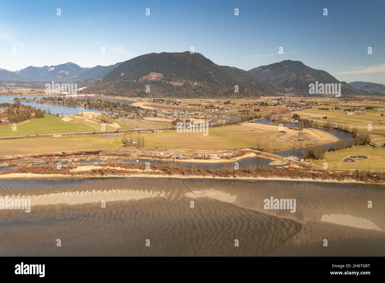 Fraser River during a drought period shows the dykes that protect the Summas Prairie in the lower Fraser River Valley in the city of Chilliwack. Stock Photo
