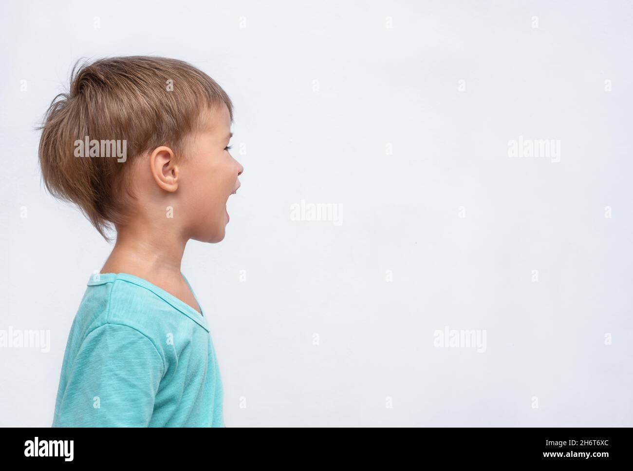 Happy child portrait in profile on gray background Stock Photo