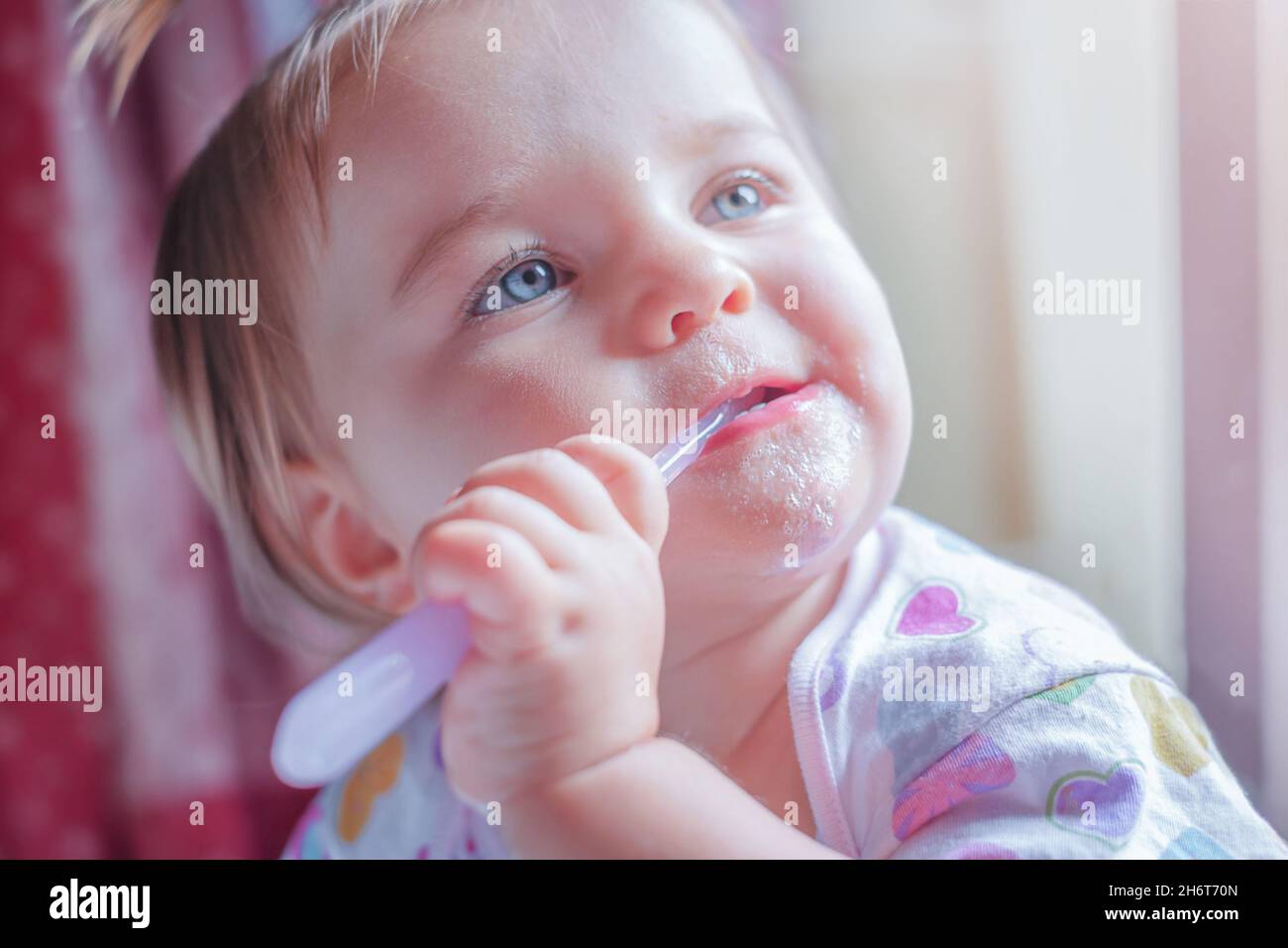 Baby's first teeth cleaning. The child cleans his own teeth Stock Photo Alamy