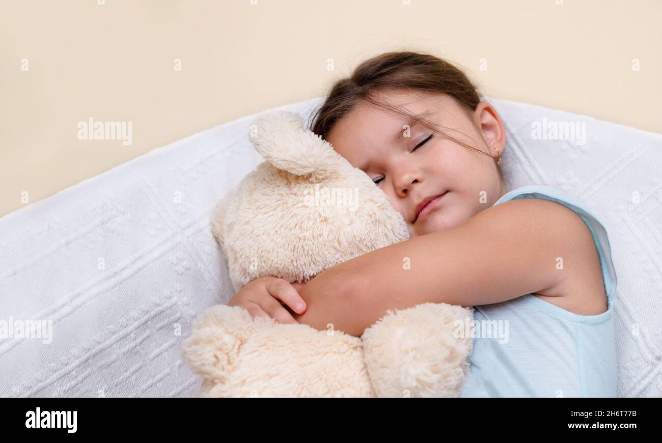 Cute child sleeping with a toy Stock Photo Alamy