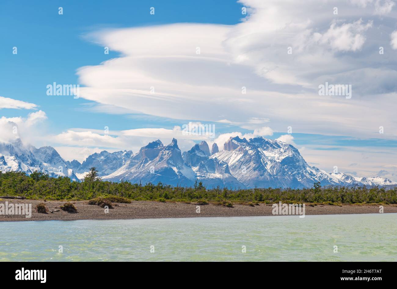 Cuernos and Torres del Paine Andes peaks with lenticular cloudsalong Serrano river, Torres del Paine national park, Patagonia, Chile. Stock Photo