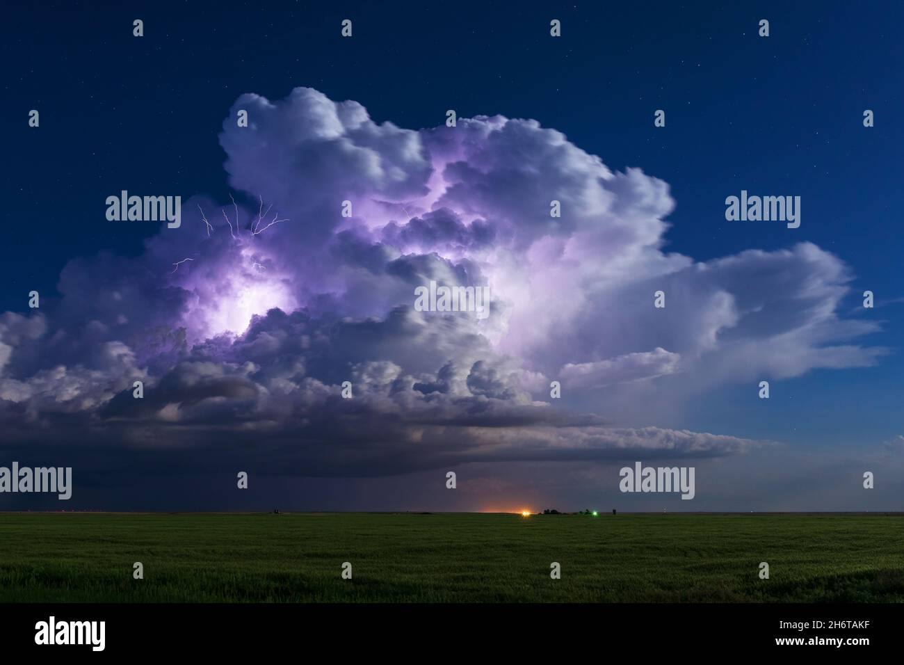 A thunderstorm cumulonimbus cloud is illuminated by lightning near Jetmore, Kansas Stock Photo