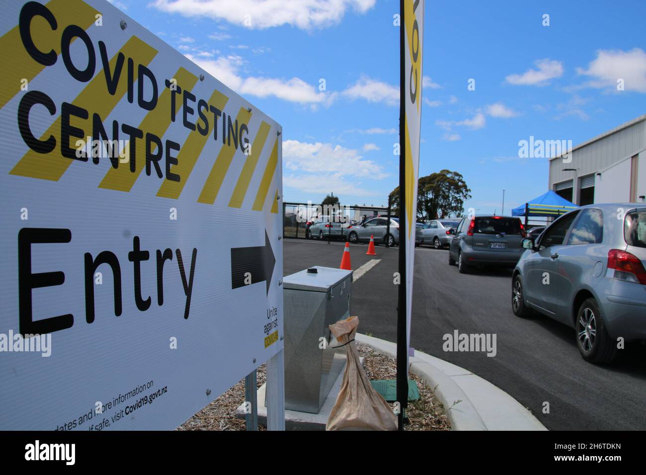 Cars line up at Covid19 testing station on Orchard Rd.A person who
