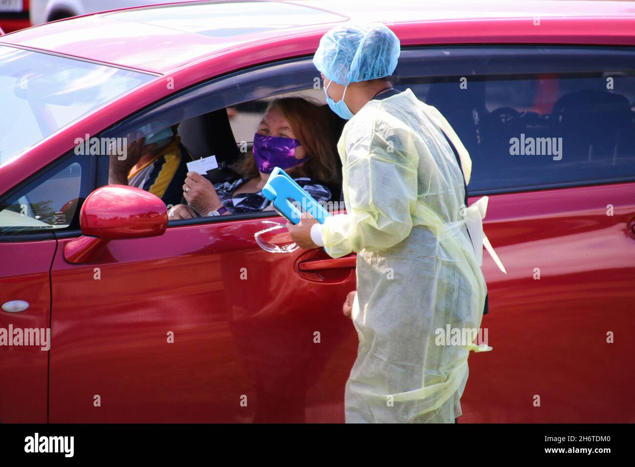 A health worker explains the testing process to a woman at a Covid19
