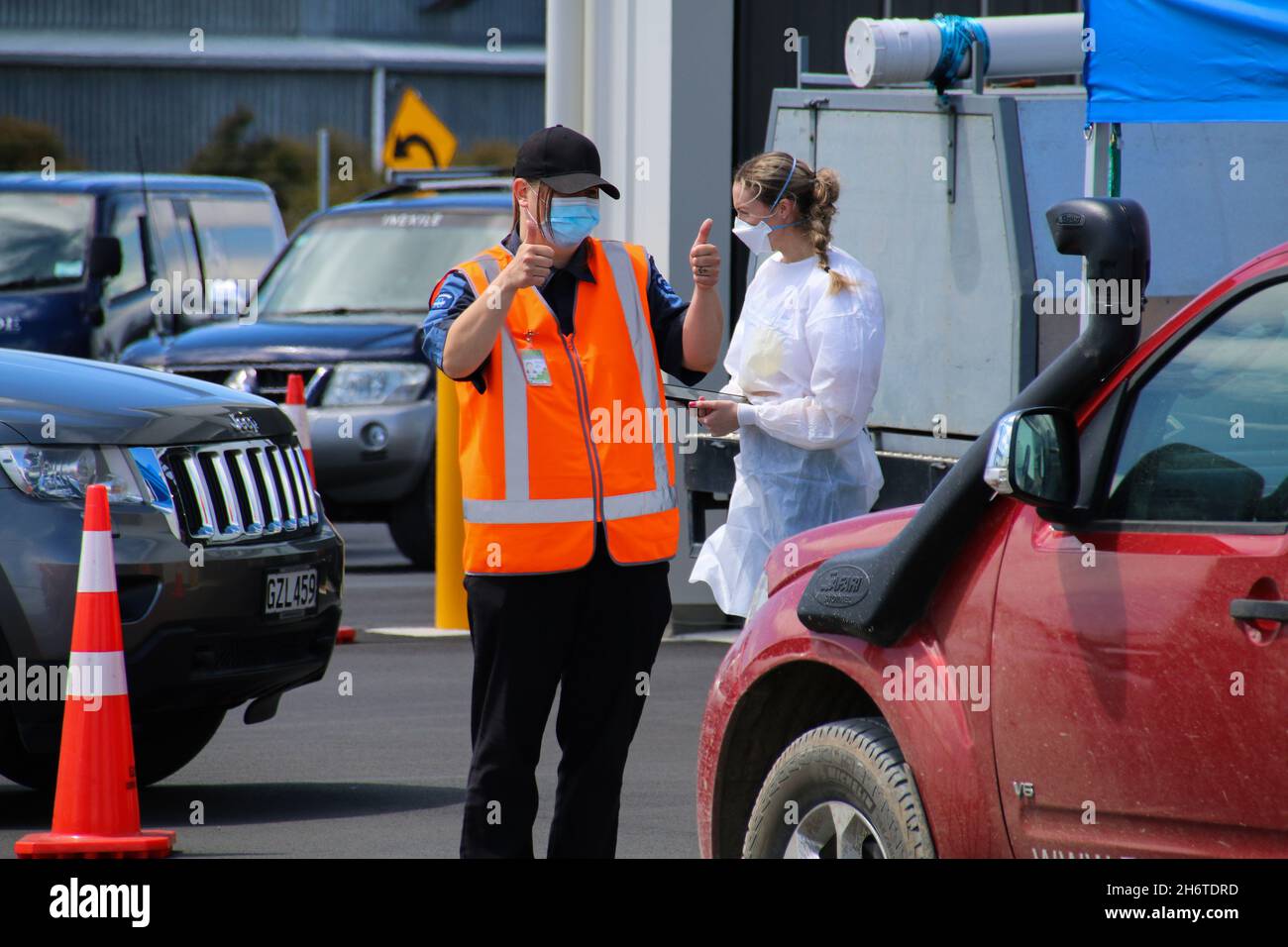 A security guard gives the thumbs up to a driver at a Covid19 testing