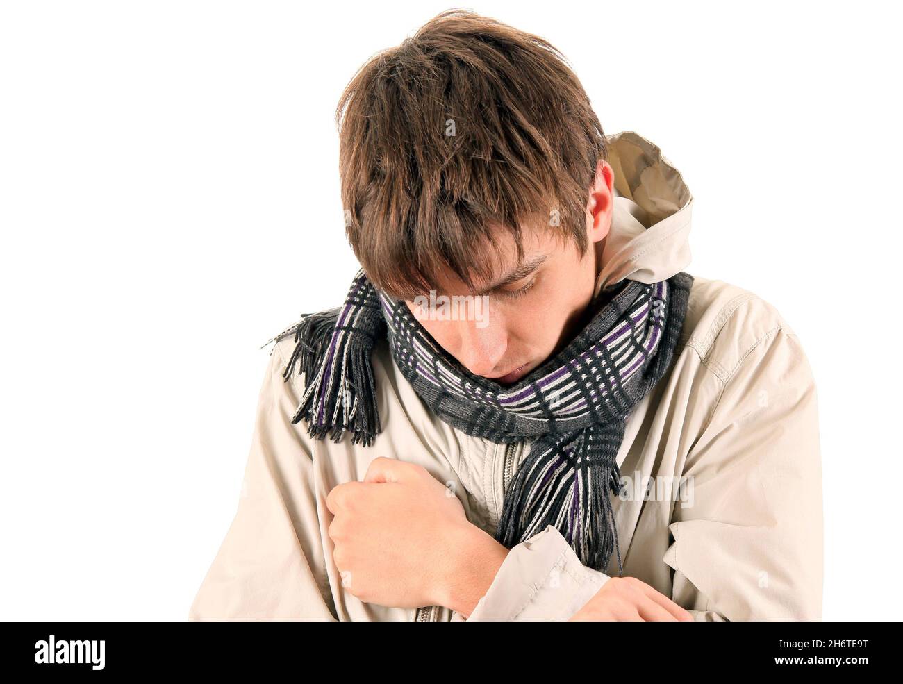 Sad and Frozen Young Man Isolated on the White Background Stock Photo