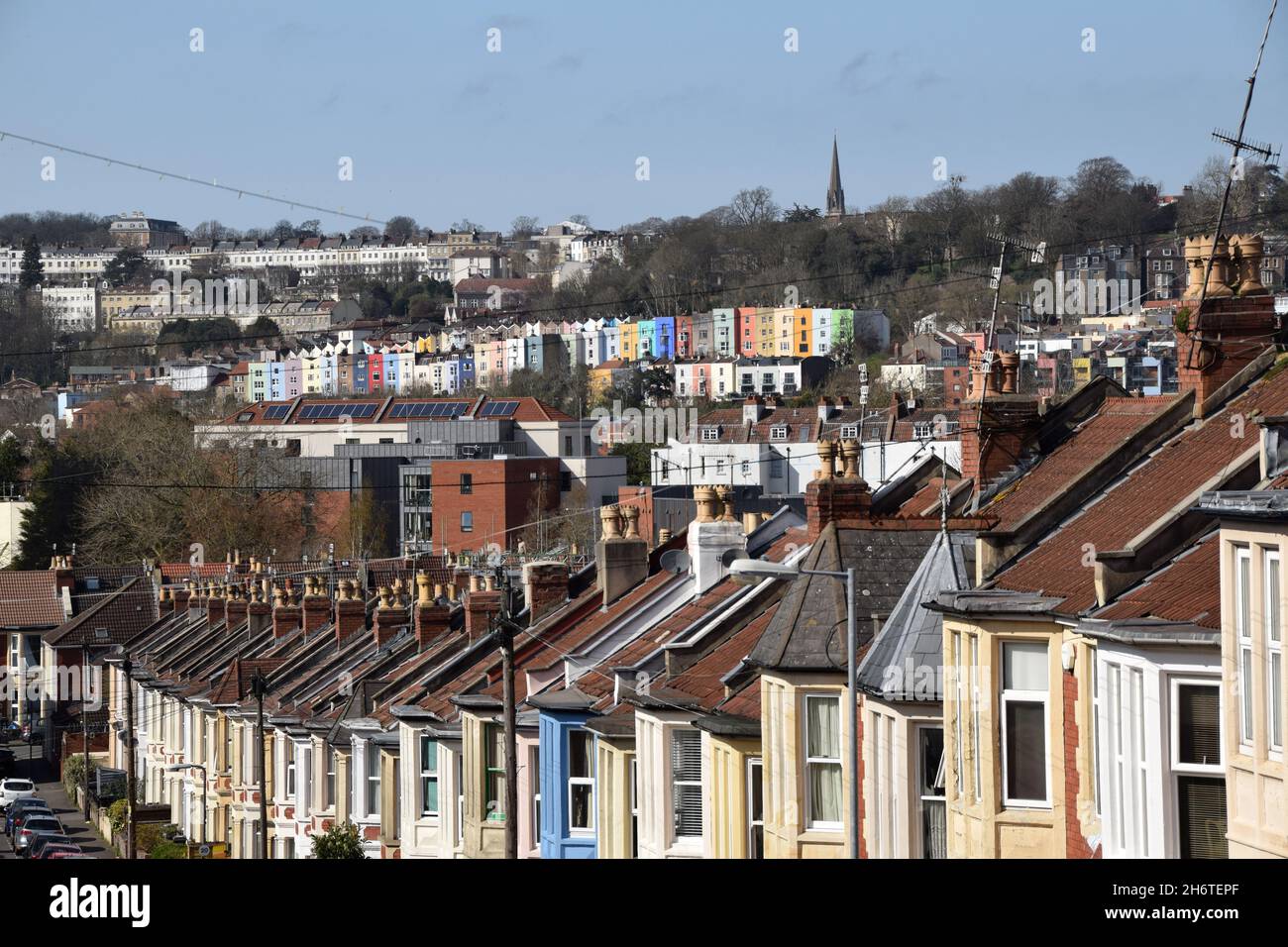 Cityscape of Bristol, UK, with Edwardian terraced houses in foreground and colourful rainbow Georgian and Victorian terraces of Clifton and Hotwells - Stock Image