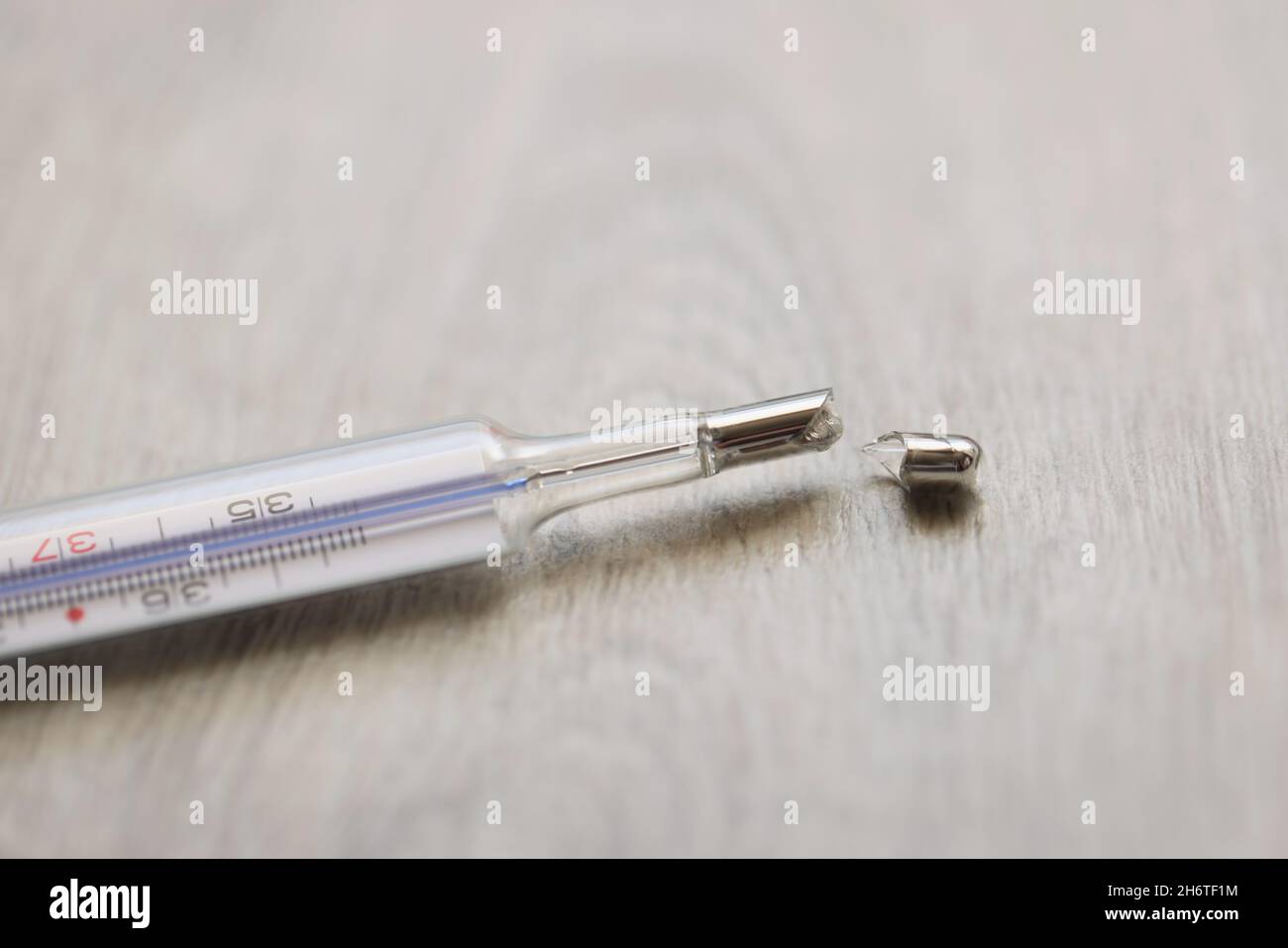 Broken glass mercury thermometer lying on floor Stock Photo Alamy