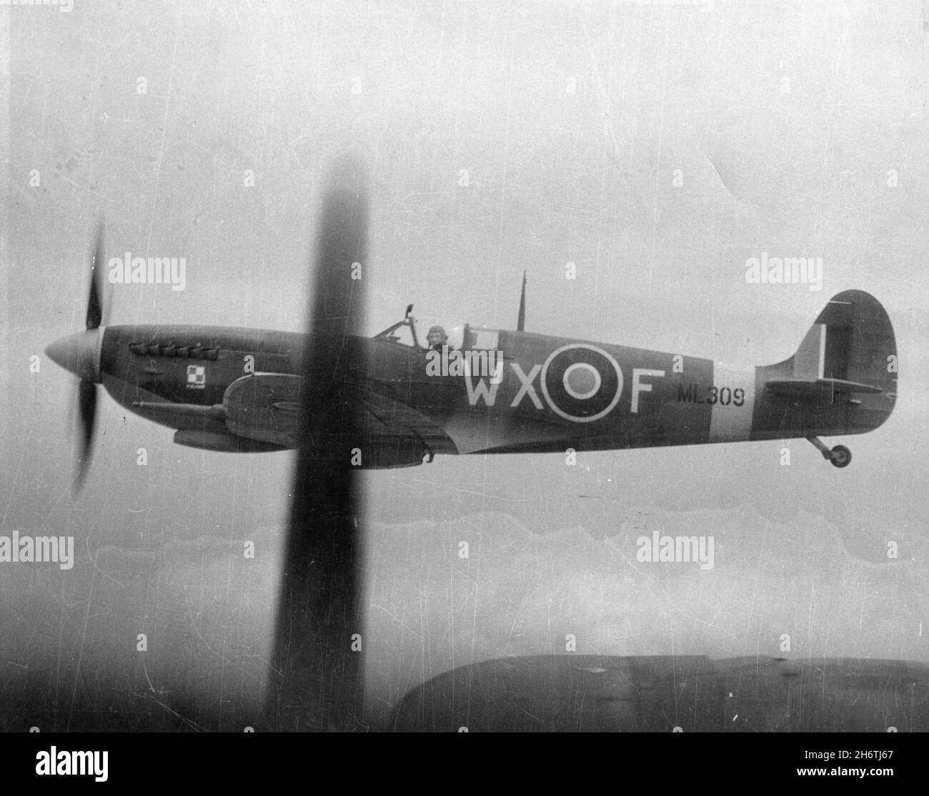 EUROPE - circa 1943 - A Royal Air Force Supermarine Spitfire off the wing of a B-17. Flown by RAF and American pilots, the short-ranged Spitfire was t Stock Photo