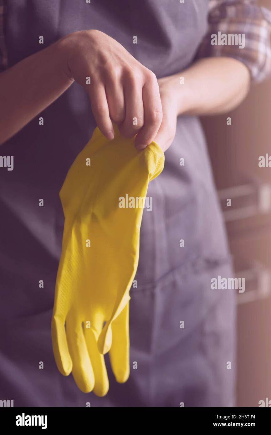 A woman in yellow rubber gloves does housework Stock Photo - Alamy