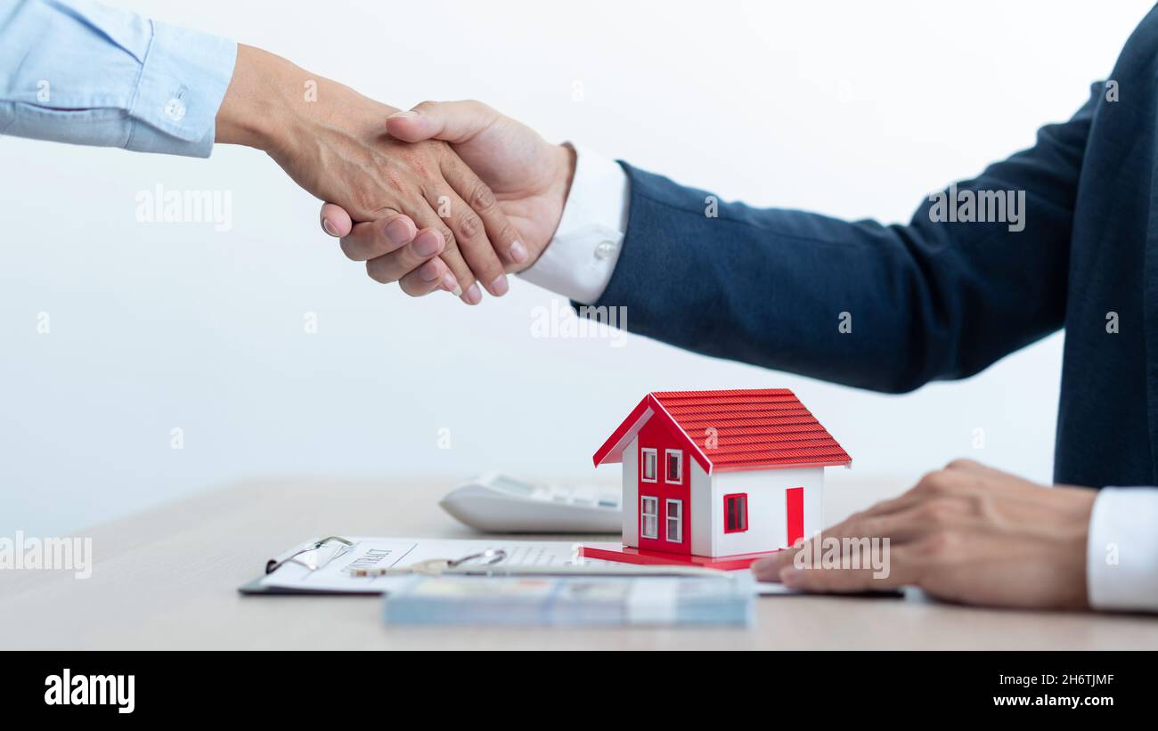 The real estate concept the house estate and his client shaking hands for accepting to make the land sale contract. Stock Photo