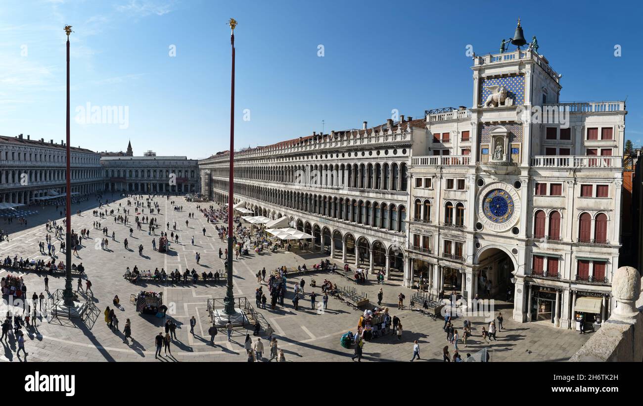 Piazza San Marco with many tourists, visitors. View from the roof of Saint Mark's Basilica with famous St Mark's Clocktower. Stock Photo