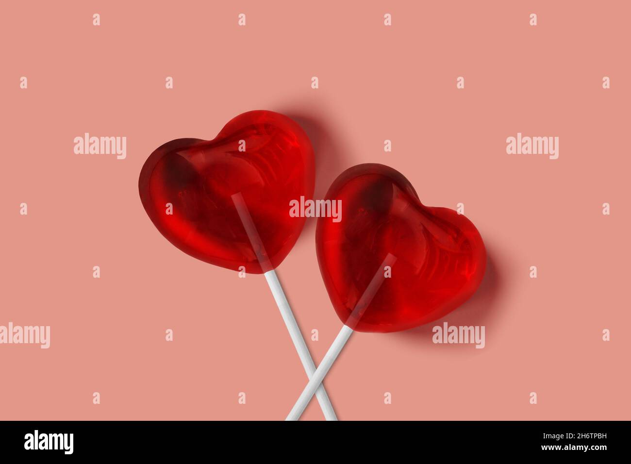 Two heart lollypops on pink background - Love and sweetness concept Stock Photo