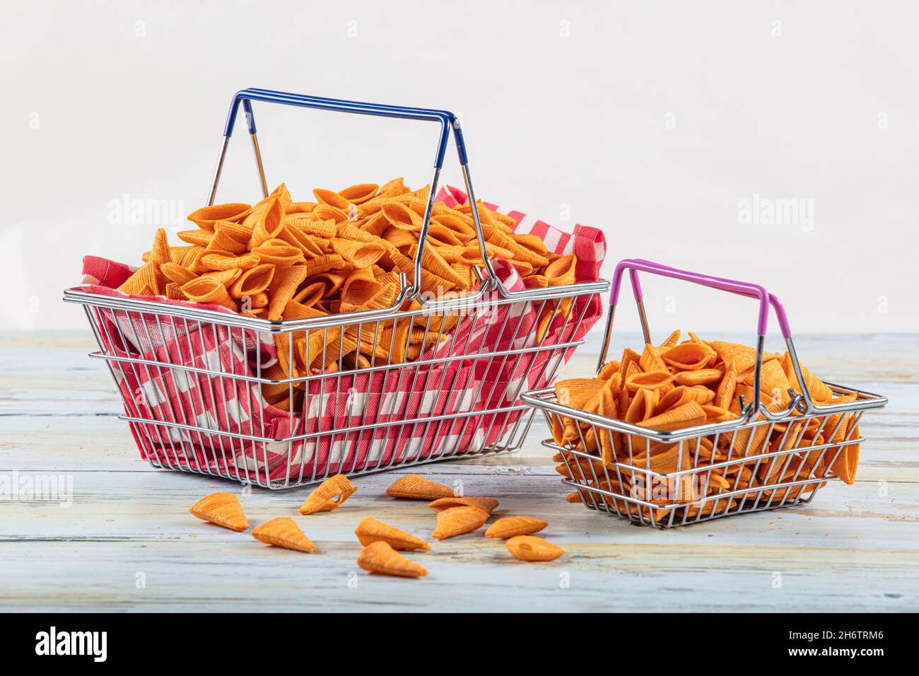 Portion of cone shaped snack tornado shaped crackers. Yellow spicy