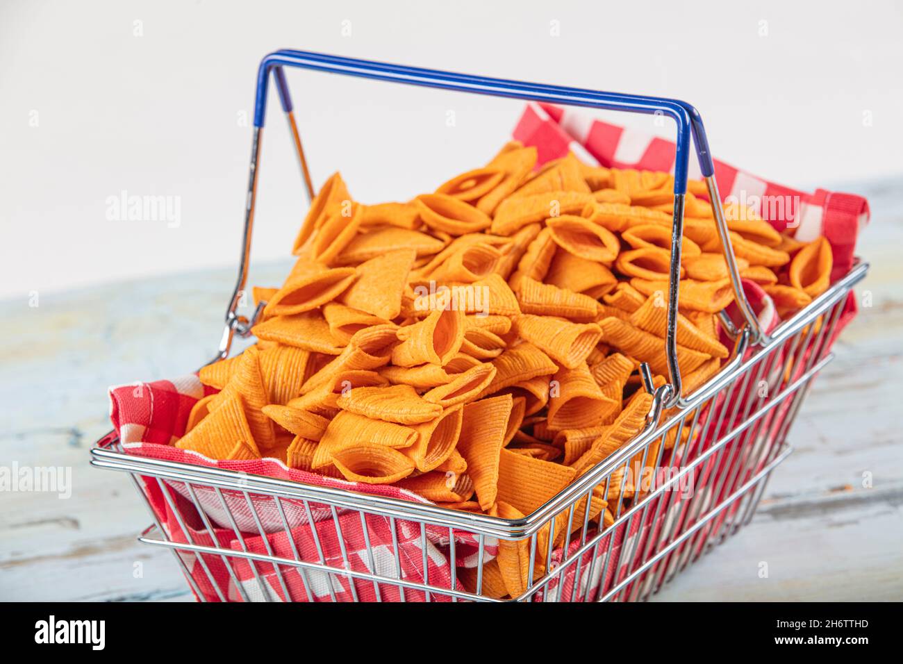 Portion of cone shaped snack tornado shaped crackers. Yellow spicy