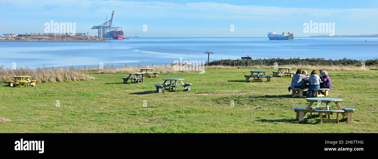 Visitors picnic table in Essex Wildlife Trust Thameside Nature Reserve & Discovery Park a November view River Thames Estuary & London Gateway Port UK Stock Photo
