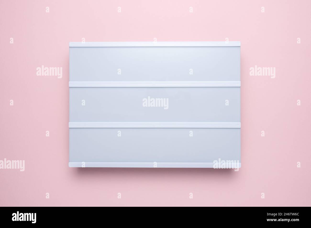 Blank lightbox on pastel pink background. Mockup concept. Stock Photo