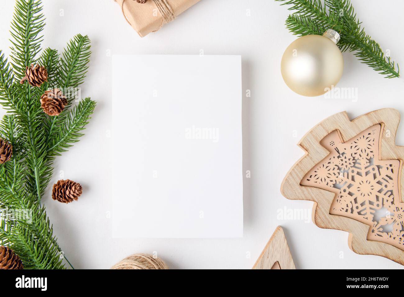 Christmas 5x7 card mockup template with fir twigs and golden stars on white background Stock Photo