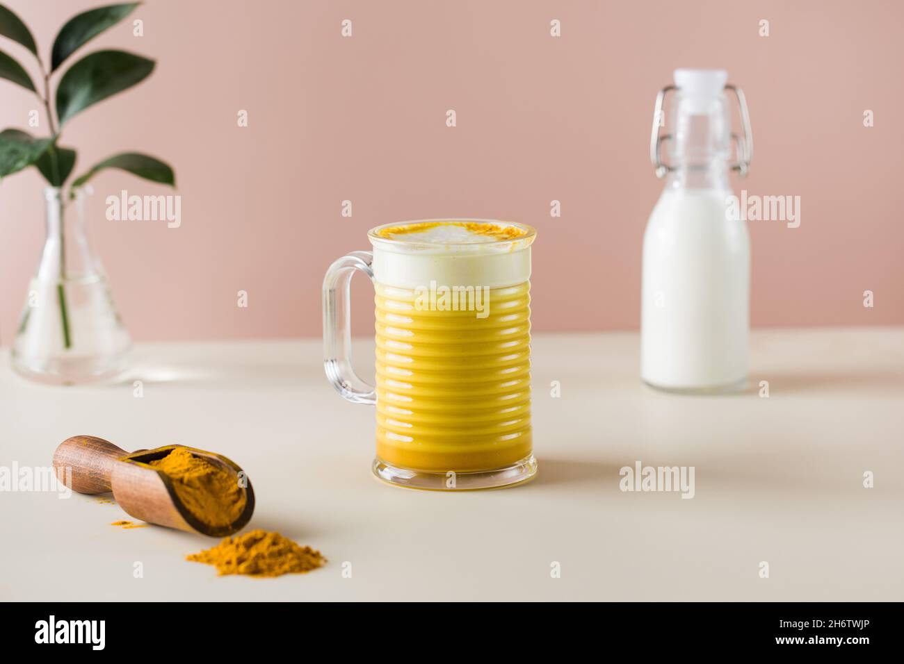 Latte turmeric on a pink background. Moon milk for better sleep. Copy
