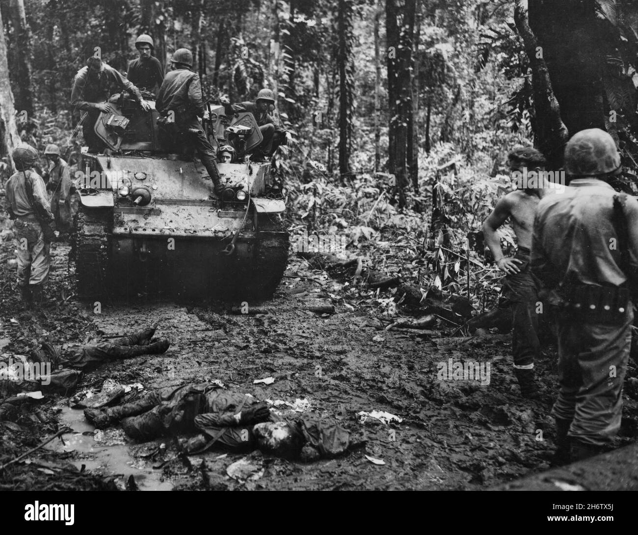 BOUGAINVILLE, PACIFIC OCEAN - circa November 1943 - US Marines on foot and in an armoured personnel carrier after an engagement with Japanese soldiers Stock Photo
