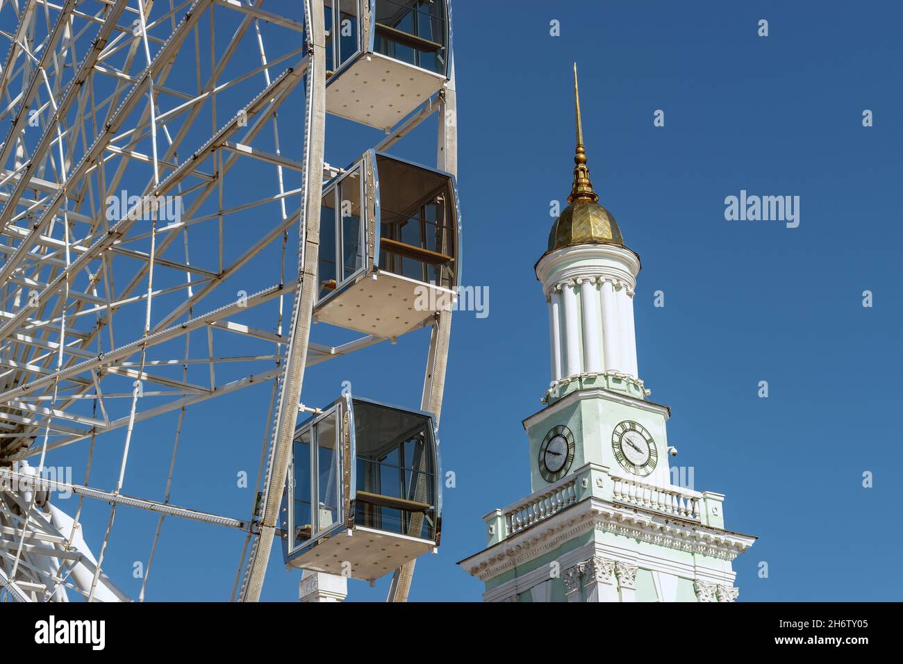 View of modern ferris wheel on background of blue sky in Kyiv city. Stock Photo